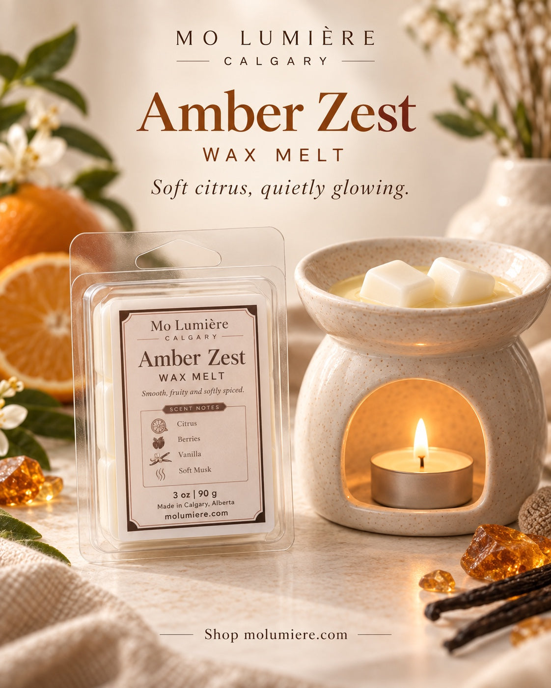 Mo Lumière Amber Zest wax melt beside a ceramic wax warmer