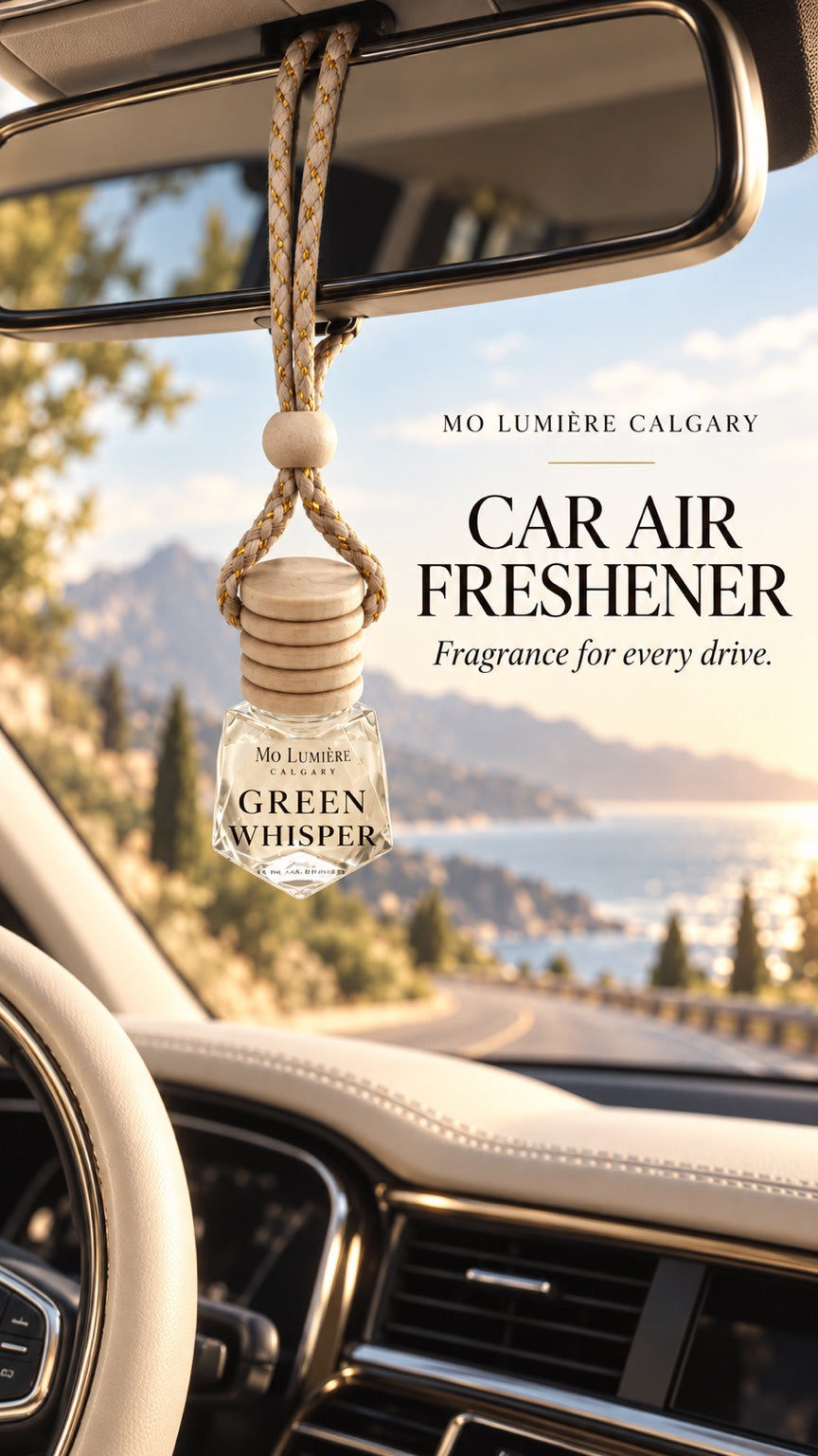 Green Whisper car air freshener hanging inside a car