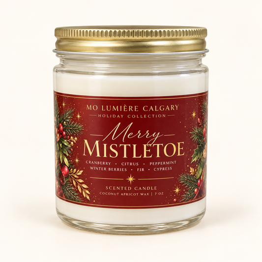 Merry Mistletoe 7 oz holiday candle in clear glass jar with gold lid and crimson Christmas label