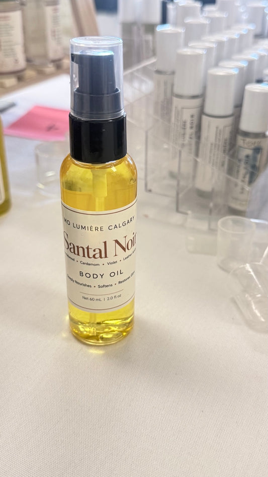 Mo Lumière Santal Noir 60 mL body oil bottle with black pump and cream label