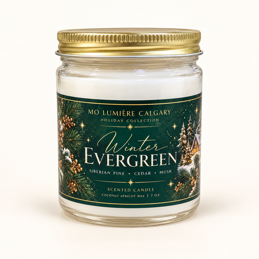 Winter Evergreen 7 oz holiday candle in clear glass jar with gold lid and forest green label